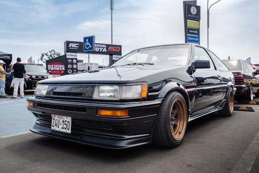 A vintage Toyota Sprinter Trueno car showcased outdoors at a car event.
